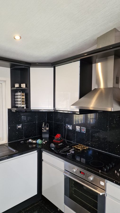 Light grey gloss wall units and cooker hood after revival