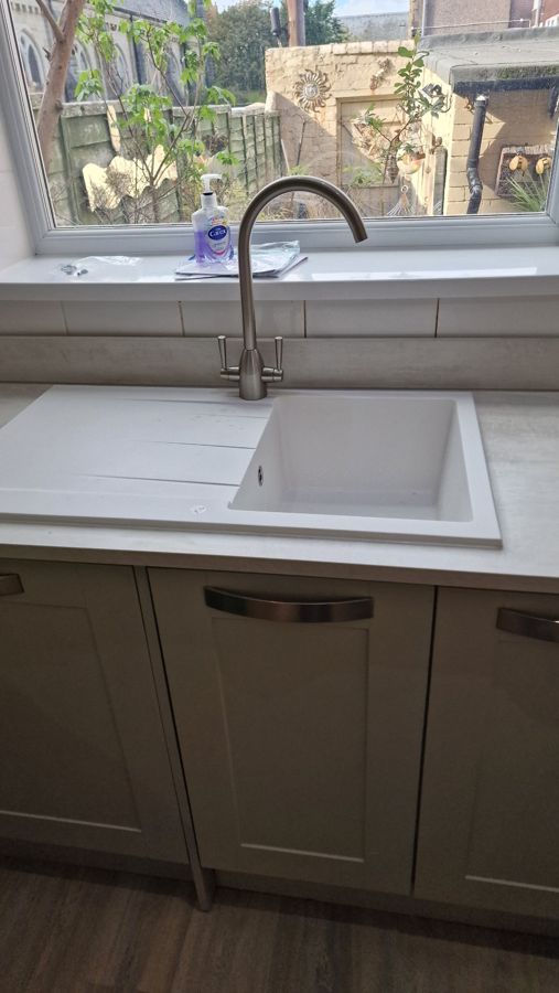 New white composite sink and light stone-effect worktop